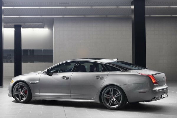 Silver Jaguar inside an underground parking lot