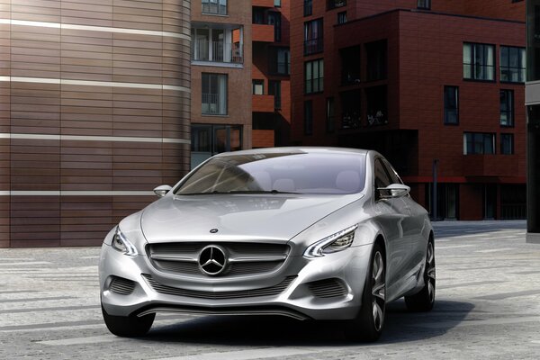 Silver Mercedes benz f800 on the background of buildings