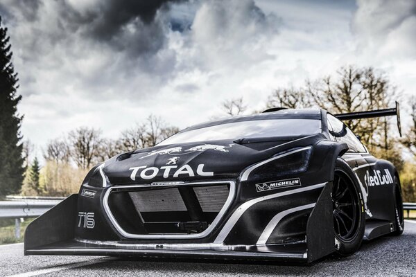 Black sports car with inscriptions on the hood and side