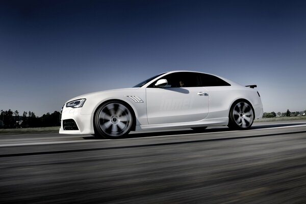 White audi rs5 driving on the road