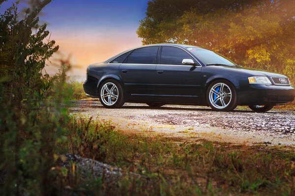 Black Audi a6 on a country road