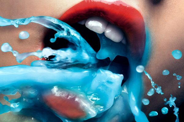 A blue liquid pours out of a mouth with red lips