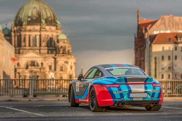 Porsche 911 tuning on the background of the cathedral beautiful sky