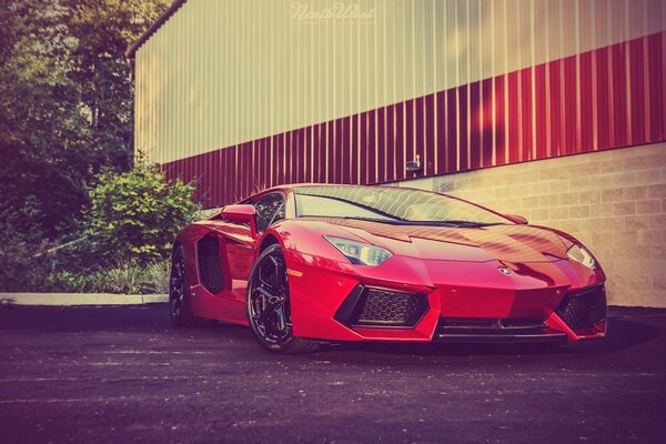 Red aventador on the background of the building