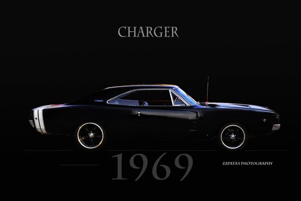 Black charger on a black background. onethousandninehundredsixtynine