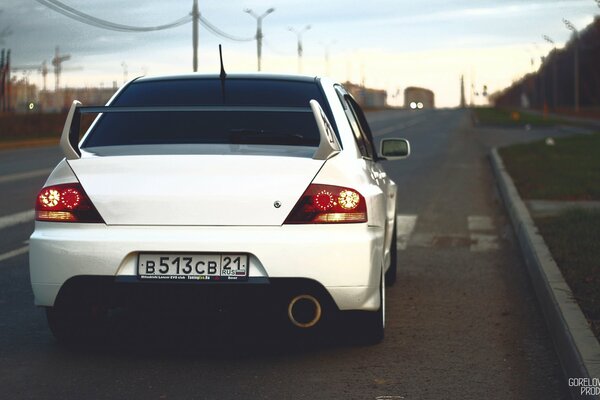 Blanc Mitsubishi sur la route de la ville