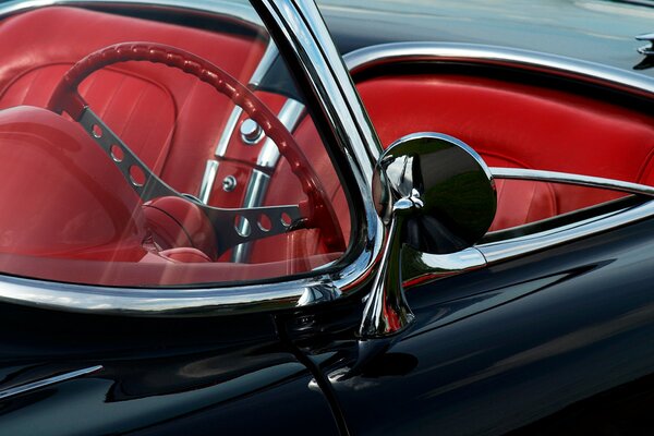 A beautiful foreign car convertible with a red interior