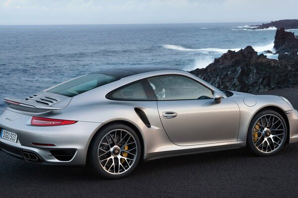 Gray porsche, 911 car with a view of the ocean