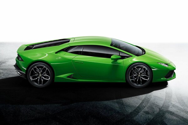 Green Lamborghini urakan on asphalt concrete