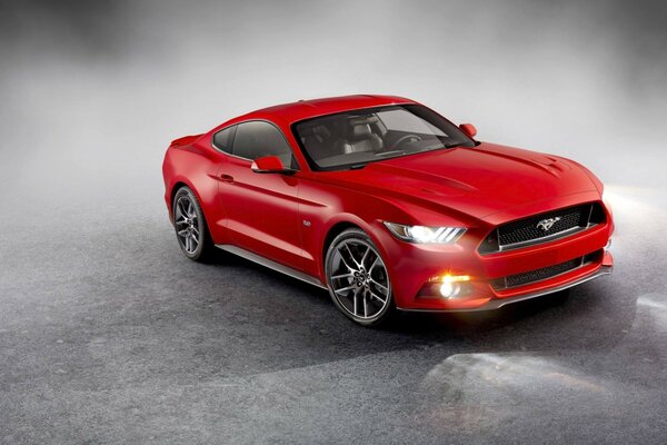 Bright red Ford Mustang with burning headlights in smoke