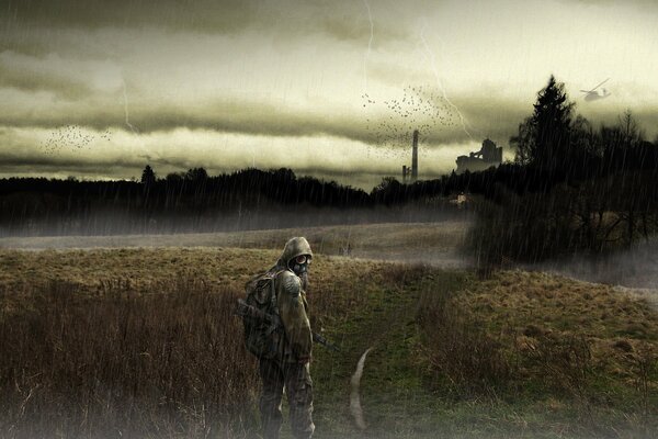 A man in a gas mask walks in the rain on a deserted forest road