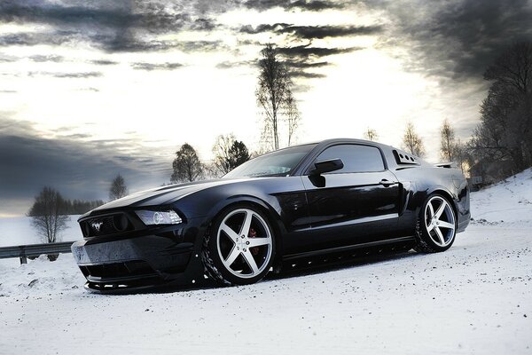 Grey Ford Mustang on the winter highway