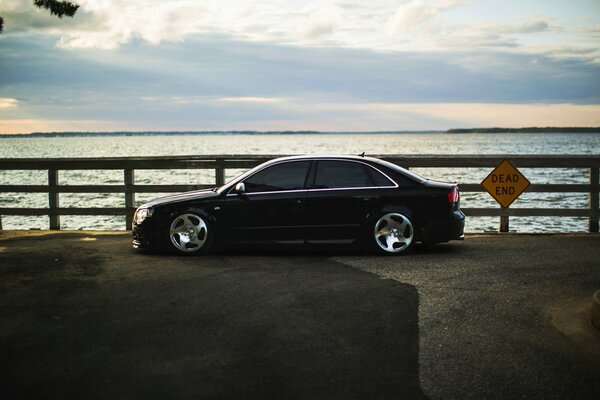 Black audi car on the seashore