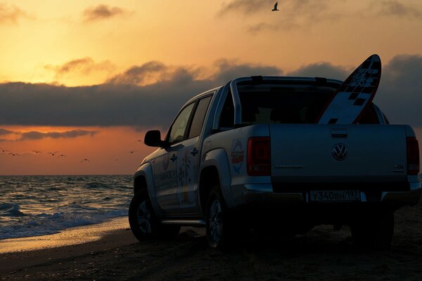 Pickup on the beach ea sunset background