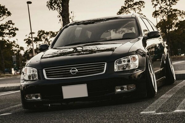 Black and white picture with a black Nissan