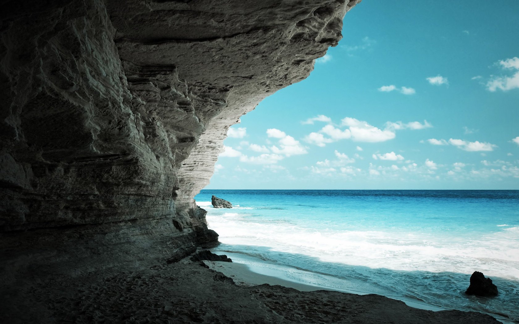 ozean küste sand felsen steine horizont himmel wolken meer brandung ansicht höhle