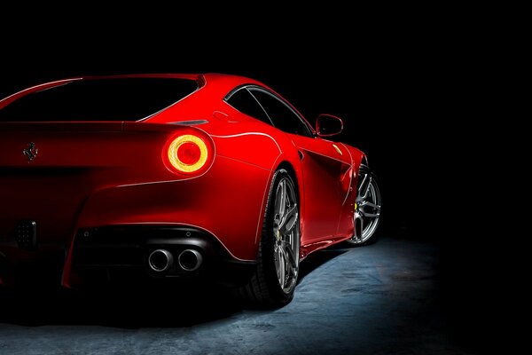 The red Ferrari shines with the taillight