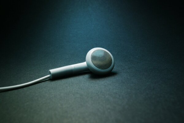 One earphone with a wire. Minimalism