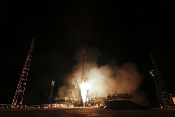 The launch of a space rocket into the dark sky