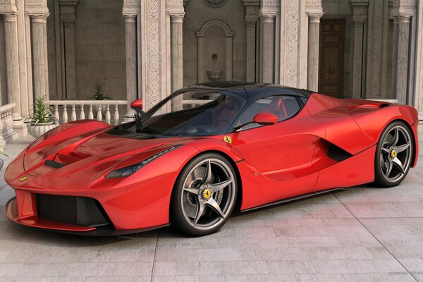 Czerwony samochód Ferrari stoi bokiem na tle budynku