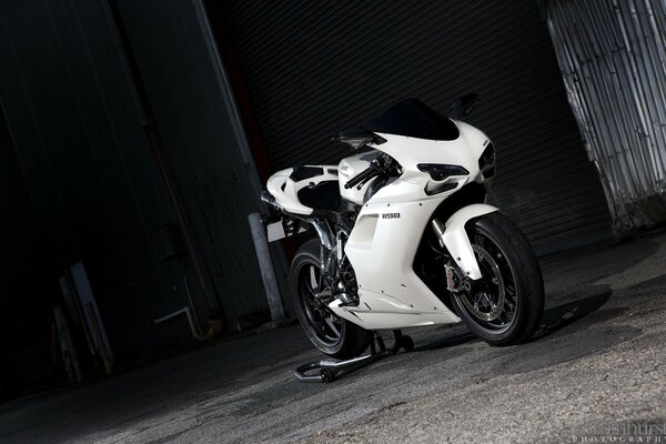 A white motorcycle on a dark background. motorbike