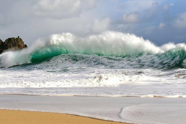 A sea storm on the shore with waves and foam