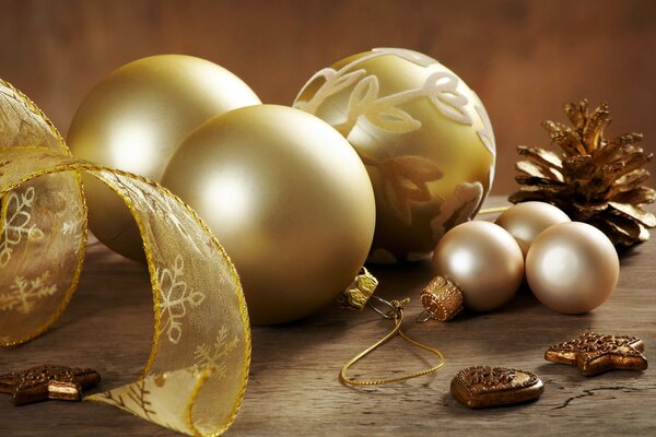 Golden Christmas balls, ribbon and gilded cone