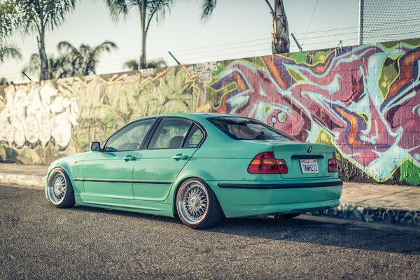 Emerald BMW 3 series on rice streets