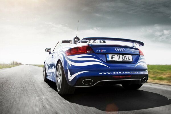 Blue audi tt car picks up speed