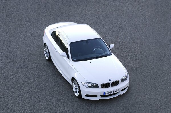 White BMW car on asphalt top view
