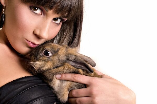 A girl with a rabbit on a white background