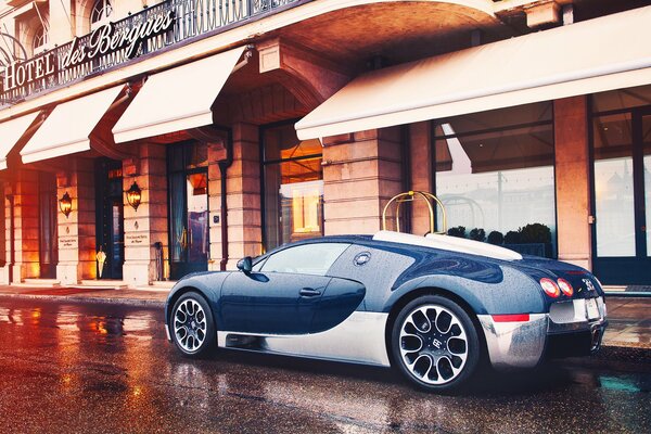 The sports car is in the city after the rain