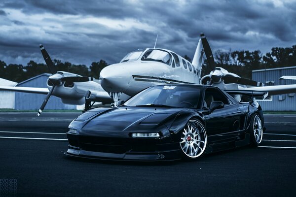 Plane and car in the airport parking lot