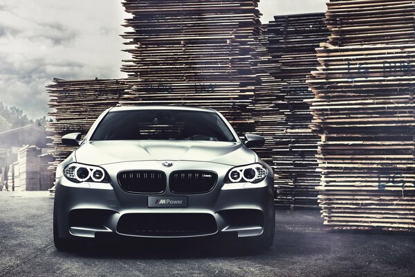 Matte grey BMW on the background of pallets