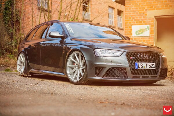 Gray audi among brick buildings