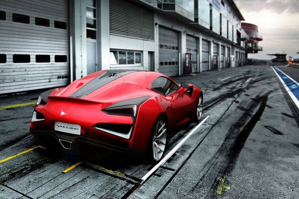 Red sports car near the building