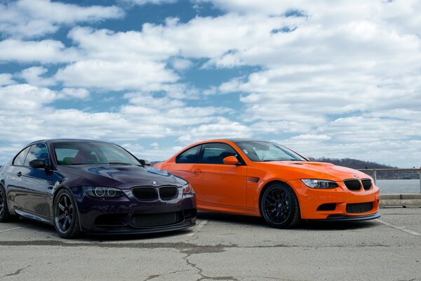 Two sports cars against the sky