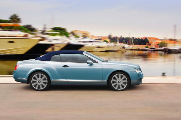 The blue bentley continental car drives forward