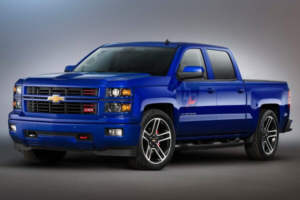 The truck is blue on a gray background