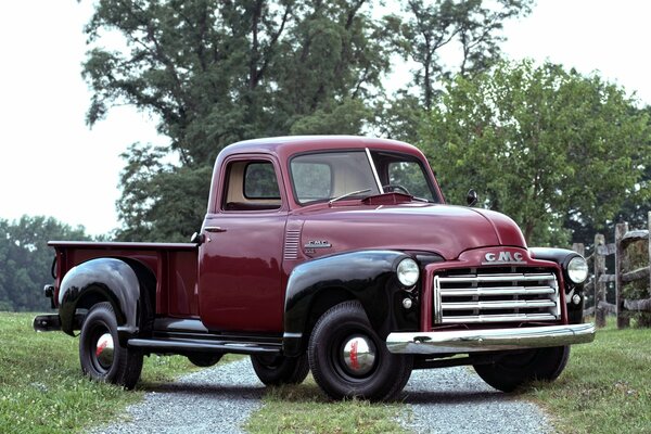 Classic burgundy car on the road