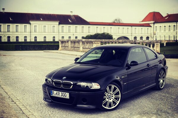 Black BMW on the background of the urban landscape