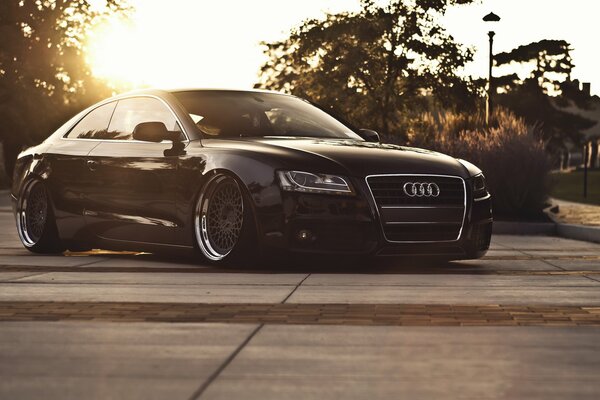 Audi a5 took a position against the background of sunset