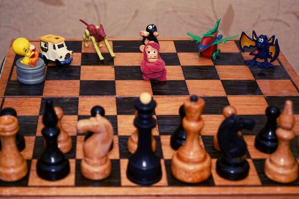 Chess board with figures and toys from kinder surprise