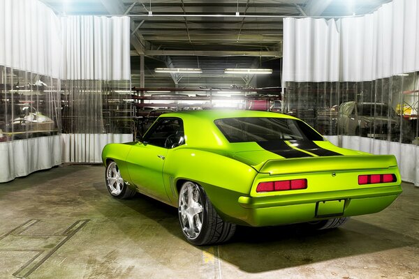 Light green Chevrolet Camaro in the garage