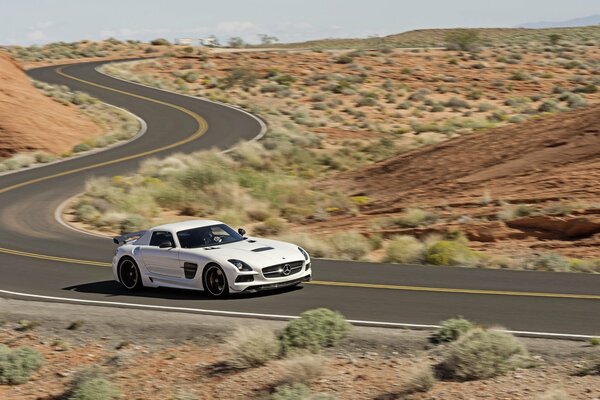 Marcedes AMG drives on the highway through the desert