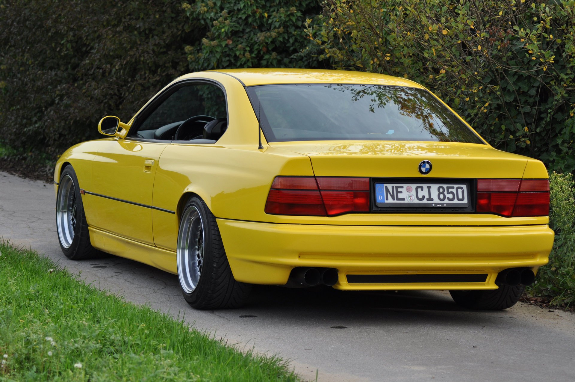 bmw 850 ci e31 bmw bmw coupé coche deportivo amarillo estilo diseño alta tecnología techno alemania baviera auto auto amarillo coche coche transporte hierba seto vegetación vista trasera follaje automóviles vehículos