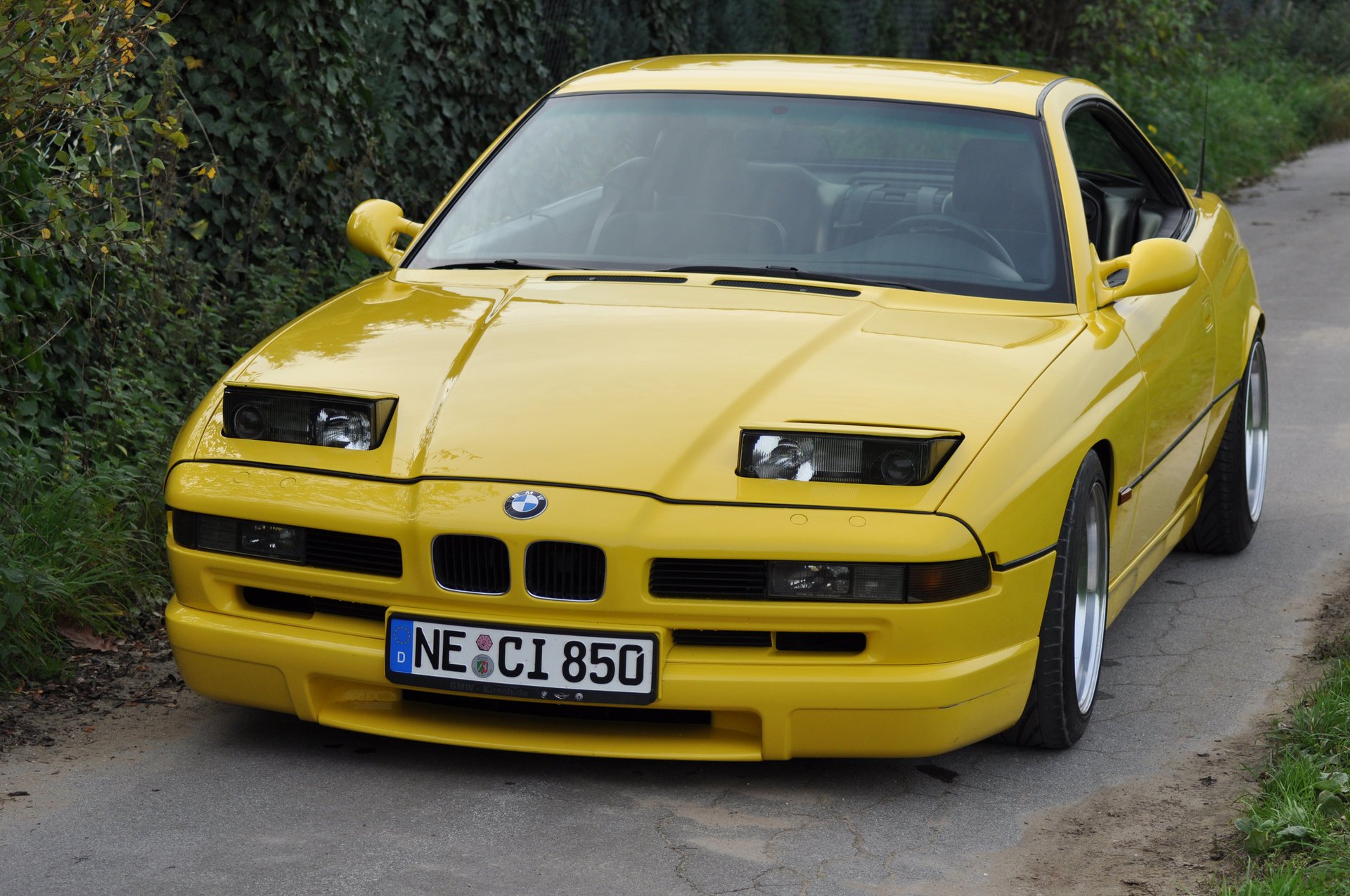 bmw 850 ci e31 bmw bmw coupe sports car yellow style design high-tech techno germany bavaria auto yellow car car car transport grass hedge front view greenery foliage passenger cars motor transport