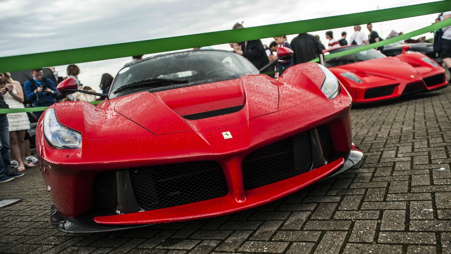 upercars ferrari laferrari enzo red town square people expos salon rain drops weather city area exhibition interior