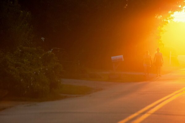 Silhouette of people walking on the side of the road