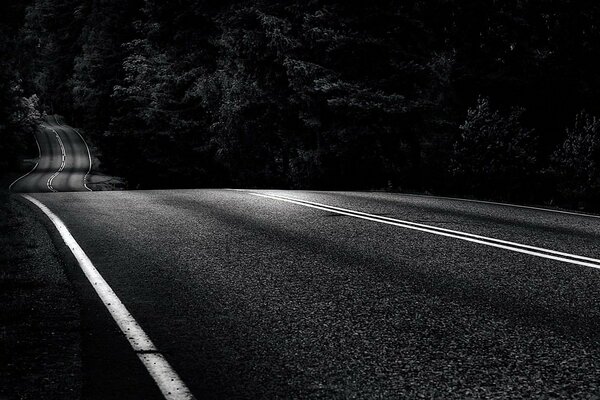 Straßenmarkierung in der Nacht. Asphalt im Dunkeln